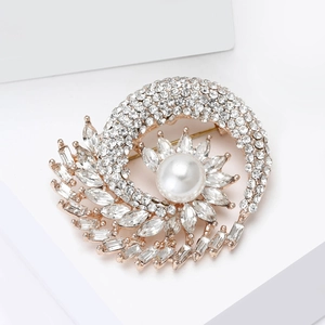 Detail view of flower brooch with a large white pearl and radiant crystal accents