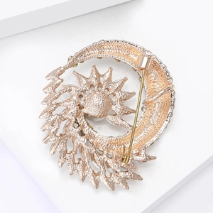 Detail view of the rose gold brooch back with hollow honeycomb texture and pin buckle clasp