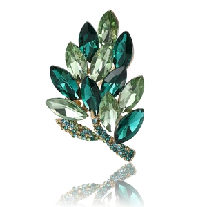 Detail of green leaf brooch with crystal marquise stones and gold-plated stems
