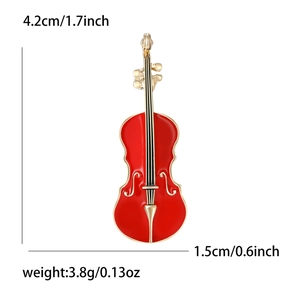 Élégante broche violon en émail rouge et métal doré avec dimensions et poids indiqués