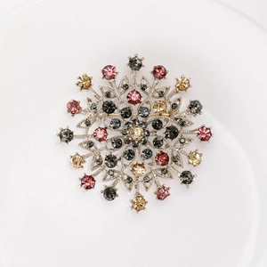 Vintage silver crystal flower brooch with colorful rhinestones in a snowflake design