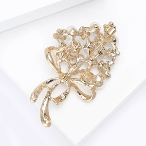 Detailed macro view of the gold flower bouquet brooch with pin back and safety clasp