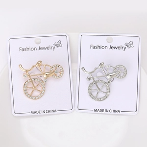 Detailed macro view of gold and silver bicycle brooches with sparkling crystal rhinestones