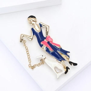 Detail of vintage enamel lady brooch with a dog in blue dress on white display
