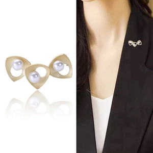 Elegant gold brushed geometric brooch with three natural pearls shown on model and white background