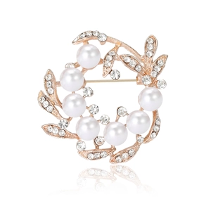 Elegant rose gold ring brooch with white pearls and sparkling crystals on white background