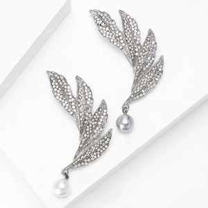 Elegant rhinestone leaf earrings with hanging pearls on minimalist geometric pedestals