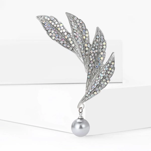 Silver leaf brooch with rainbow rhinestones and grey pearl pendant on white background