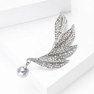 Detail of silver leaf brooch with sparkling rhinestones and grey pearl pendant