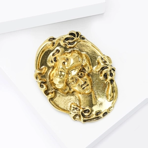 Classic vintage gold alloy brooch featuring an elegant female portrait relief cameo