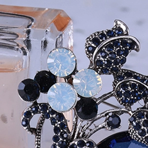 Macro shot of vintage tulip brooch with deep blue rhinestones and silver metal finish