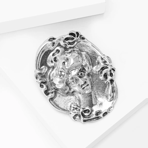Detailed macro view of vintage cameo brooch with antique silver finish and lady profile