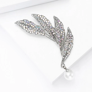 Detail of silver leaf brooch with sparkling AB rhinestones and a white pearl drop charm