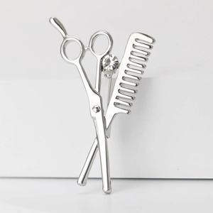 Barber theme silver brooch featuring crossed scissors and comb with a small crystal
