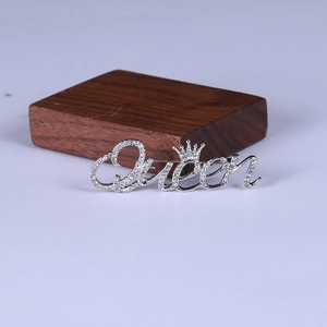 Detail of silver Queen letter brooch with crown and crystal rhinestones for women