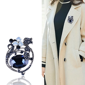 Elegant vintage navy blue tulip brooch with crystals on a beige trench coat