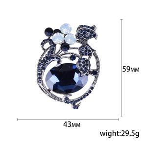 Vintage silver flower brooch with large blue gemstone and white rhinestones, 59x43mm size