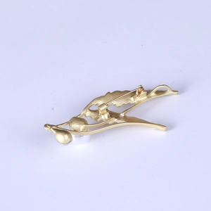 Matte gold angel wing brooch with pearls and rhinestones shown from the back view