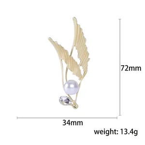 Elegant gold feather brooch with large white pearl and crystal drop charm, 72mm height