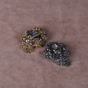 Close-up of vintage baroque brooches with teardrop crystals and sparkling rhinestones