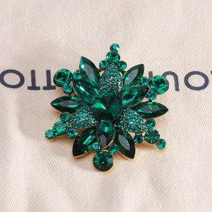 Detail of emerald green flower brooch with crystal petals and marquise zircons