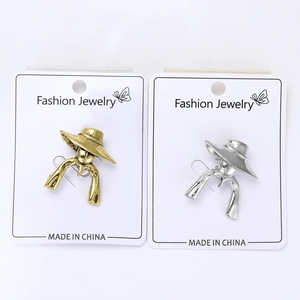 Detailed close-up of gold and silver vintage portrait brooches on display cards