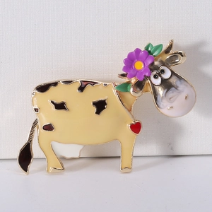 Detail of cartoon cow enamel pin with purple flower and heart, alloy base close-up