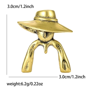 Detailed view of retro gold female figure brooch with hat, size 3.0cm by 3.0cm