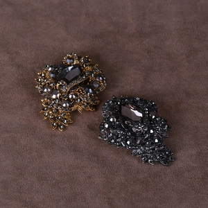 Elegant rhinestone brooch pin with marquise crystal in gold and black finish