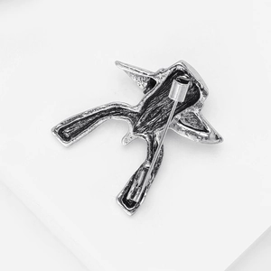 Detail view of the vintage silver metal bird brooch back showing the safety pin clasp
