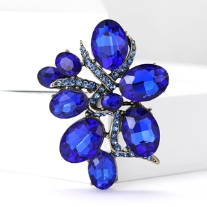 Macro detail of high-end vintage flower brooch with deep blue rhinestones and gold alloy