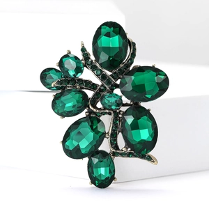 Detailed macro shot of vintage emerald green crystal brooch with zinc alloy base
