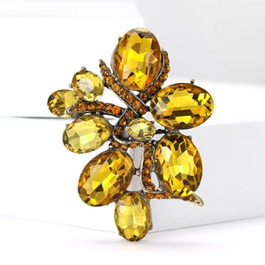 Detailed close-up of amber faceted gemstones on a vintage bronze brooch pin