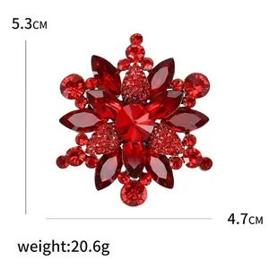 Sparkling crystal flower brooch with red rhinestones measuring 5.3 cm by 4.7 cm