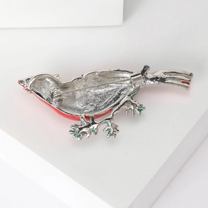 Minimalist silver bird brooch with red enamel detail and secure pin safety clasp back