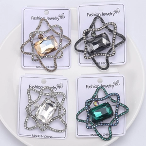 Detailed macro view of crystal glass brooches in various colors on white display cards
