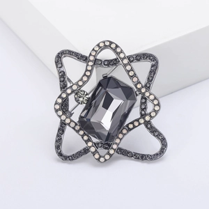 Elegant geometric brooch with grey crystal and pavé rhinestones on white display