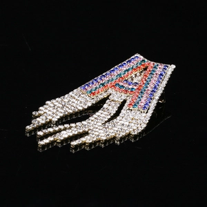 Close-up of colorful crystal letter A brooch with five rows of sparkling tassel fringes
