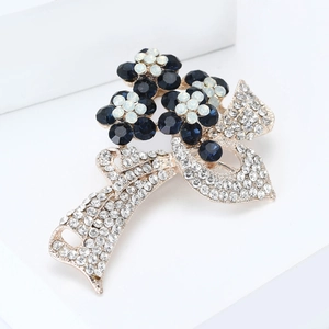 Broche fleur dorée élégante avec cristaux bleu marine et ruban orné de strass brillants