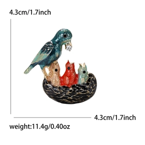 Enameled woodpecker bird brooch with colorful feeding scene and crystal accent