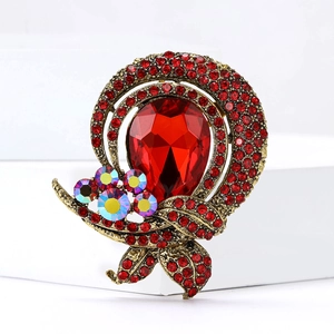Vintage gold alloy brooch with large ruby-red teardrop stone and crystal pavé details