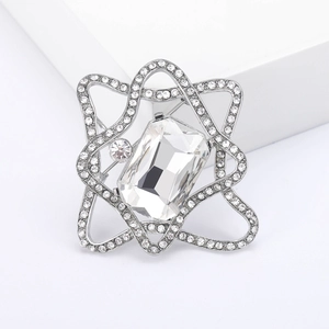 Silver star brooch with a large rectangular crystal and sparkling zircon micro-pave