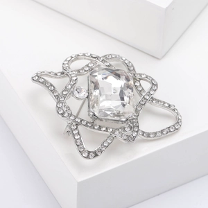 Macro detail of high-quality crystal brooch with rectangular gemstone and silver alloy diamonds