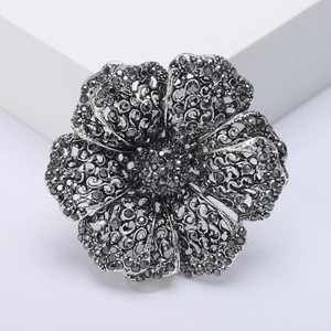 Vintage hollow flower brooch with grey crystals and retro metal finish for women