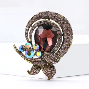 Vintage pear-shaped glass brooch with purple crystals on a bronze alloy base