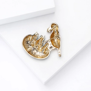 Detailed back view of a gold cat brooch showing the secure rotating safety pin clasp