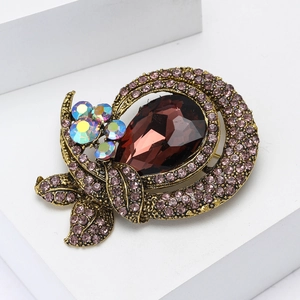 Vintage gold alloy brooch with brown teardrop gemstone and purple crystals on stone