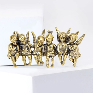 Detailed close-up of vintage gold alloy angel brooch featuring six classic cupid figures