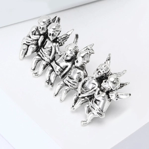 Vintage silver alloy brooch with six Cupid angel figures on white display stand