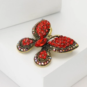 Exquisite gold-plated butterfly brooch with deep red rhinestones and crystal accents